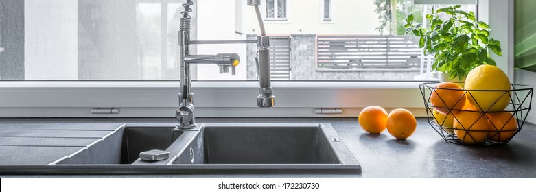 Close Up On Modern Double Basin Kitchen Sink With Steel Tap In Solid Granite Worktop And Fruits On, Panorama