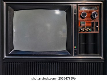 Close Up On An Old Cathode Ray Television Monitor With Plastic Buttons For UHF And VHF Settings Designed To Emphasize Analog TV Broadcast Shows, Movies And Video Games.