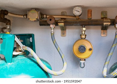 Close Up On One Gas Cylinder Connected To The LPG Regulator And To The Residual Gas Detector. Gas Cylinders For Domestic Use With Outdoor Position. View Of The Gas Installation And Control System.