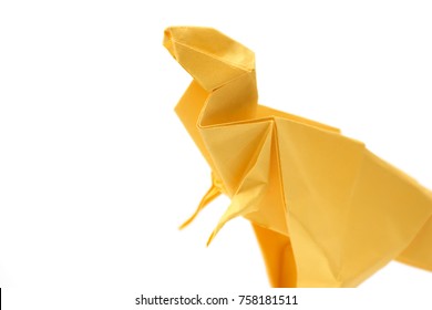 Close up on origami tyrannosaurus, isolated on white. Miniature made of folded paper. Piece of craftsmanship.