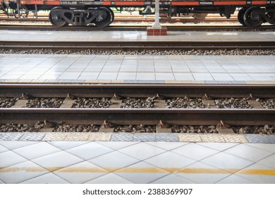 Close up on part of railroad track from side view on a train station