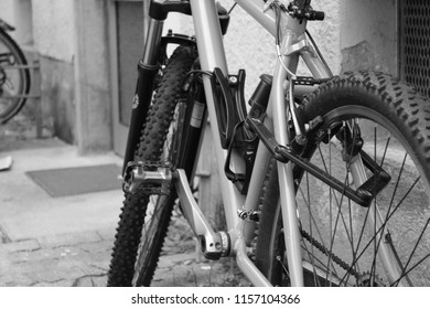 Close up on parts of bicycles in black and white.