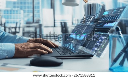 Close Up on Person's Hands Using a Laptop Computer with Analytical Data Presented in Futuristic Holographic Visualization with Graphs and Charts. Anonymous Man Working on Reports in a Modern Office