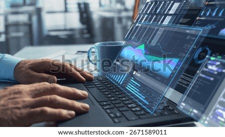 Close Up on Person's Hands Using a Laptop Computer with Analytical Data Presented in Futuristic Holographic Visualization with Graphs and Charts. Anonymous Man Working on Reports in a Modern Office