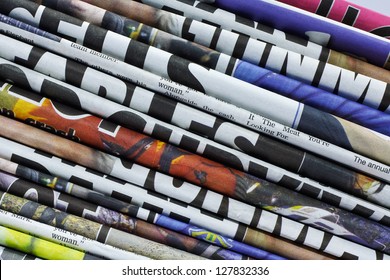 Close Up On A Pile Of Differnt Color Newspaper Titles