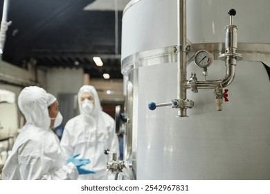 Close up on pressure gauge and pipes on stainless steel tank in workshop of food or chemical factory, copy space - Powered by Shutterstock