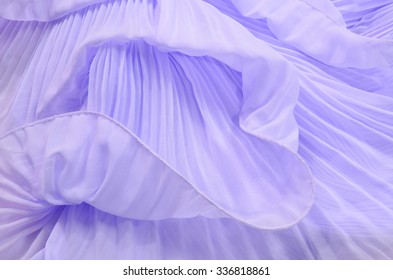 Close up on purple pleated lace. Pastel violet crumpled tulle as background.