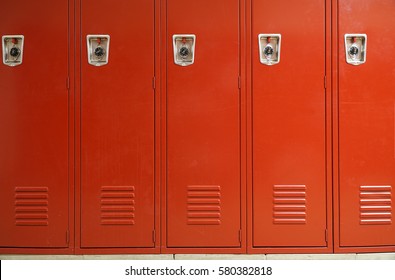 close up on red lockers in gym