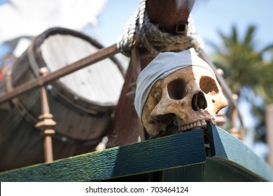 Close Up On A Replica Human Skull Wearing A Bandana Placed As An Ornament On The Bow Of A Pirate Ship