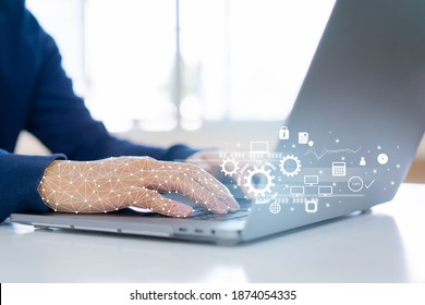 close up on robot (ai) hand working on laptop to checking correct data by use RPA function software program to help proof and detect and synchronize to system for future technology of business concept - Shutterstock ID 1874054335
