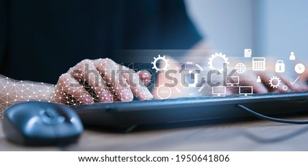 close up on robot (ai) hand working on laptop to checking correct data by use RPA function software program to help proof and detect and synchronize to system for future technology of business concept