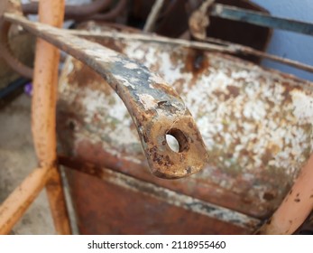 Close Up On A Rusty Corroded Metal Bar That's Bent  With A Hole At The End