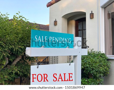 Close up on For Sale and Sale Pending sign in front of a California Home. Housing crisis, selling homes.