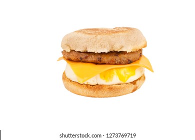 Close Up On A Sandwich Breakfast Isolated On White Background. English Muffin, Egg, Cheese, Lettuce And Sausage.