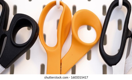 Close Up On Scissors Handle Hanging From Peg Board As A Storage Idea For Craft Room Or Workshop Wall