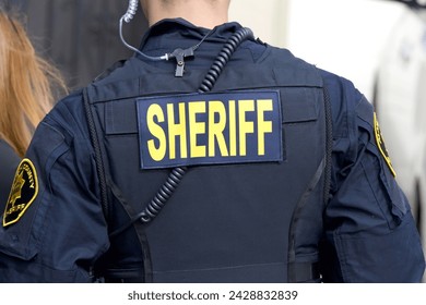 Close up on Sheriff title logo on back of flack jacket.