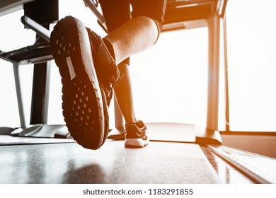 Close Up On Shoe,Women Running In A Gym On A Treadmill.exercising Concept.fitness And Healthy Lifestyle 