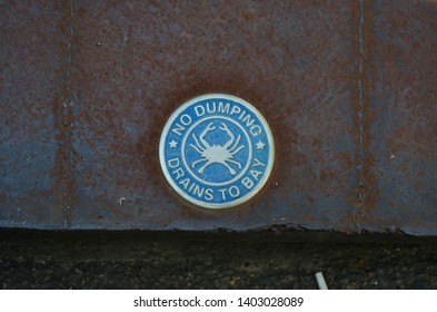 Close Up On Sign On Storm Drain, No Dumping Drains To The Bay