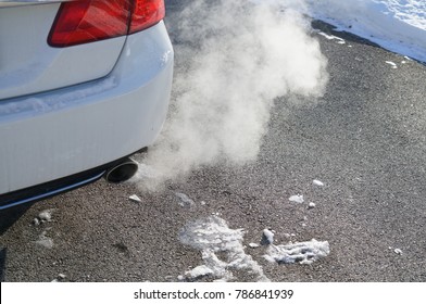 Close Up On Smoke From Car Pipe Exhaust In Winter Season   