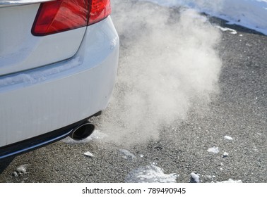 Close Up On Smoke From Car Pipe Exhaust In Winter Season