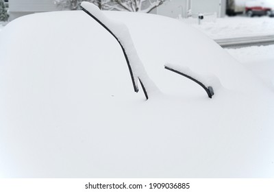 Close Up On Snow Covered Car Parked On The Driveway        