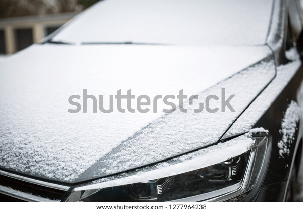 Close up on a snow covered\
car.