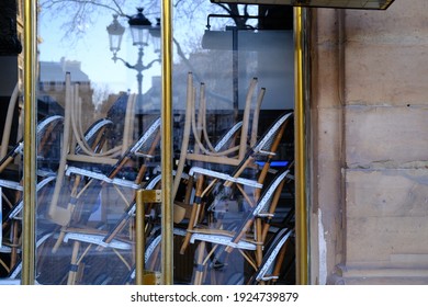 A Close Up On Some Chairs Stacked At A Parisian Café.