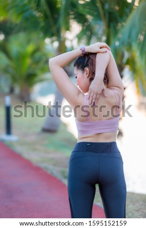Close up on sporty woman runner running in park, female in sport cloth jogging at park