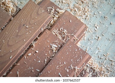 Close Up On A Stack Laminate Wood Flooring Boards, Covered In Saw Dust And Shavings, At A Home Remodel