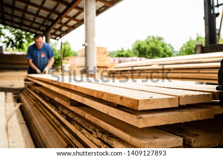 Close up on stack of rough sawn timber pine lumber planks construction material