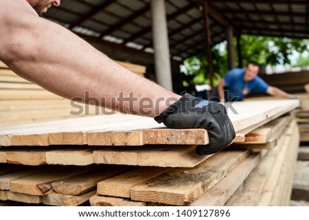 Close up on stack of rough sawn timber pine lumber planks construction material