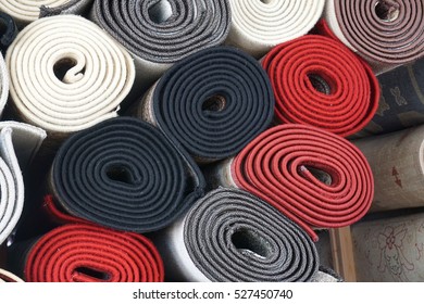 close up on stacking carpet rolls