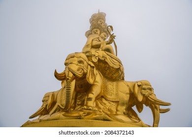 Close Up On The Statue Of The Golden Buddha From Below On The Summit Of The Mount Emei, Sichuan, China. Elephants And Faces. UNESCO World Heritage Site 