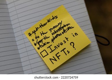 Close Up On A Sticky Note With A Todo List Stuck On A Blank Page Of A Notebook. The Highlighted Task Is To Invest In Nft