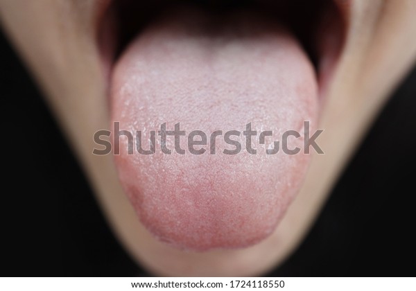 Close up on taste bud on\
woman tongue