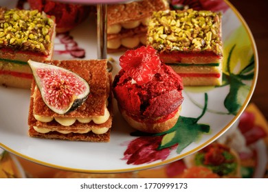 Close Up On A Tea Set Selection With Fig Cake And Raspberry Scone