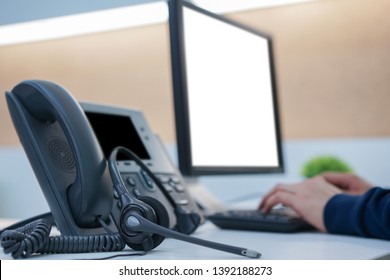 Close Up On Telephone Office Desk With Employee Call Center Man Hand Typing On A Keyboard At Desktop Pc For Working In Operation Room , Communication Technology Concept