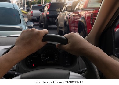 Close Up On Two Hand Of People Driving Inside Car And Many Cars On The Road Jam In Traffic Junction By Red Light Control, Rush Hour In Thailand On Day.