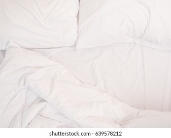 Close Up On White Bed Sheet And Pillow, A Comfortable And Cozy Bedroom