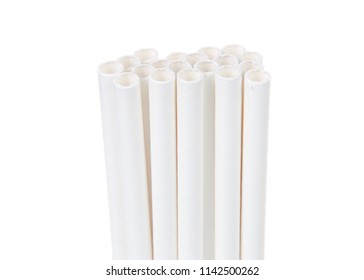 Close up on white paper straws facing upwards isolated on white background.  ecologically friendly yet durable paper drinking straws.