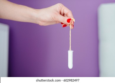 Close Up On Woman Holding White Cotton Tampon In Hand. Woman Period