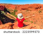 close up on woman with open arms at the edge of Kings Canyon. In Watarrka National Park. King Canyon Rim Walk of Red Center Outback in the Northern Territory of Australia