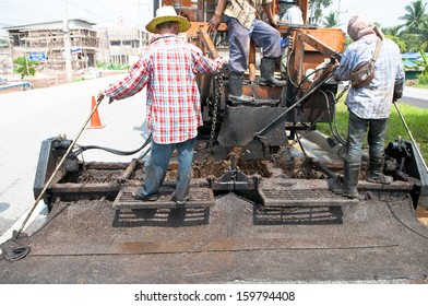 Close Up On Workers Operation Paving Road Renovation By Asphalt Para Slurry Seal Truck