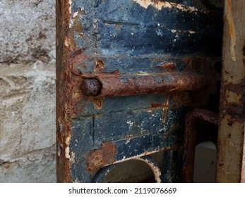 Close Up On A Worn Out Butler Door With Paint Peeling Off And Scratches And Rust All Over