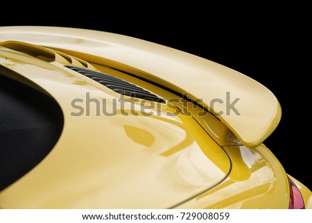 Close up on yellow sport car rear spoiler