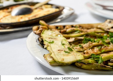 Close Up On Zucchini Courgette Summer Squash Salad With Garlic And Oil On A White Plate On The Table