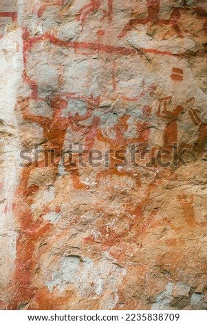 Close up on The Zuojiang Huashan Rock Art Cultural Landscape. They depict human figures as well as animals along with bronze drums, knives, swords, bells, and ships.