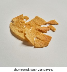 Close Up Of One Broken Tasty And Appetizing High-calorie Potato Chip Isolated On White Background. Unhealthy Eating And Fast Food. Crispy Snack For Leisure. Studio Shoot. Copy Space. Nobody