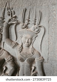 A close up of one of the devatas adorning the upper gallery walls with interesting hairstyles and crown, as well as a more slender face than her sister devatas, Angkor Wat, Angkor Archaeological Park, Siem Reap Province, Cambodia. 