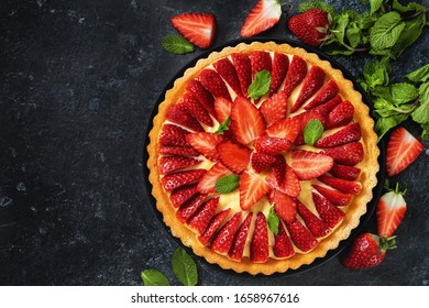 Close Op Of Strawberry Flan Cake Around Berries And Mint